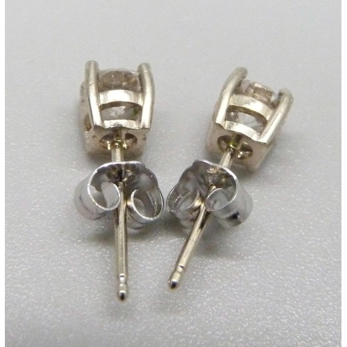 1111 - A pair of 18ct white gold and diamond stud earrings, approximately 0.90ct weight