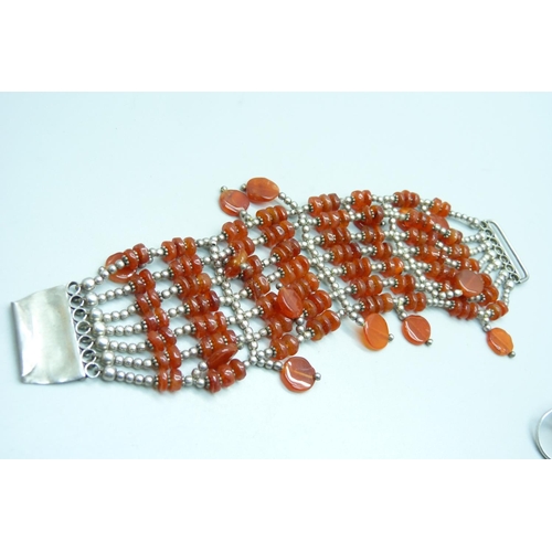 1125 - A silver and Carnelian bracelet and an amber ring, ring size L