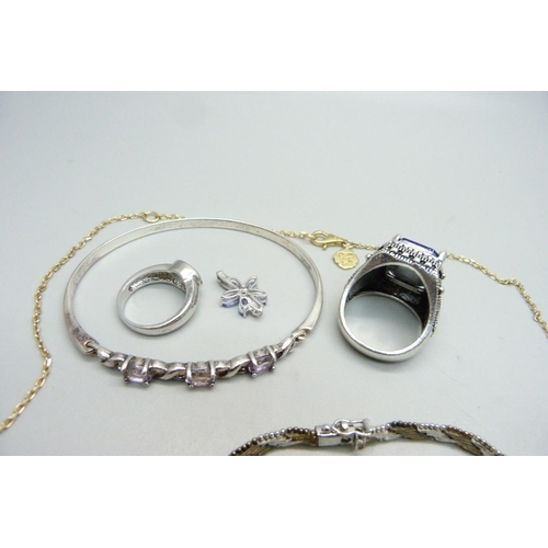 1150 - Two silver bracelets, a silver bangle, two silver rings, etc.