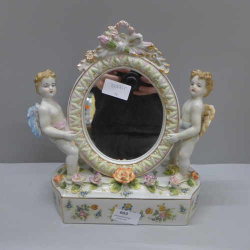 603 - A continental porcelain cherub table mirror, 27.5cm