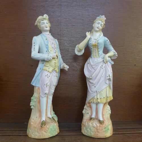 604 - A pair of continental bisque figures, 32.5cm