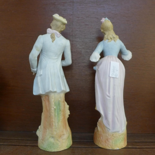 604 - A pair of continental bisque figures, 32.5cm