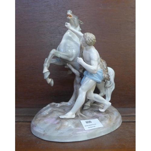 606 - A continental porcelain figure of a man and a horse, horse leg a/f