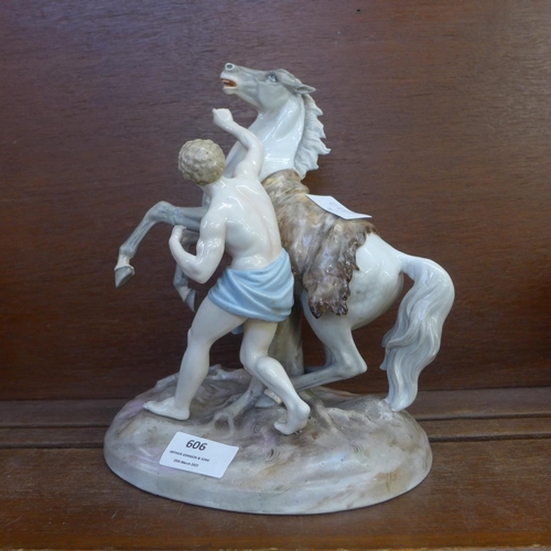 606 - A continental porcelain figure of a man and a horse, horse leg a/f