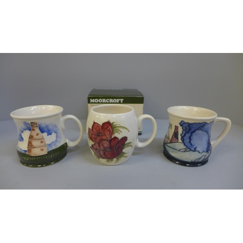 628 - Three Moorcroft mugs including 1985 marked Liberty on the base and one with box