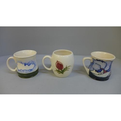 628 - Three Moorcroft mugs including 1985 marked Liberty on the base and one with box