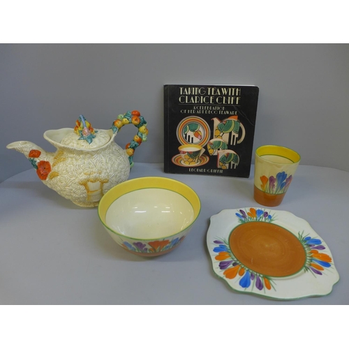 644 - A Clarice Cliff Crocus pattern bowl, beaker, side plate, and a Harvest pattern teapot and book