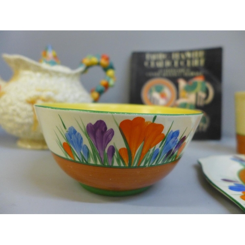 644 - A Clarice Cliff Crocus pattern bowl, beaker, side plate, and a Harvest pattern teapot and book