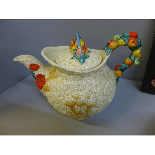 644 - A Clarice Cliff Crocus pattern bowl, beaker, side plate, and a Harvest pattern teapot and book