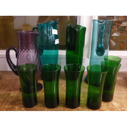 805 - Four coloured glass jugs and six drinking glasses