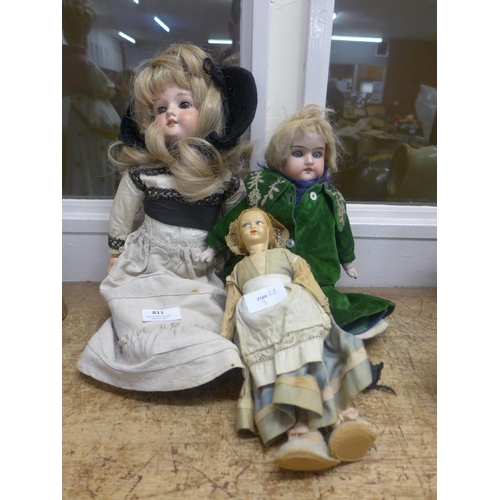 811 - An Armand Marseille doll, one other bisque head doll and a cloth faced doll