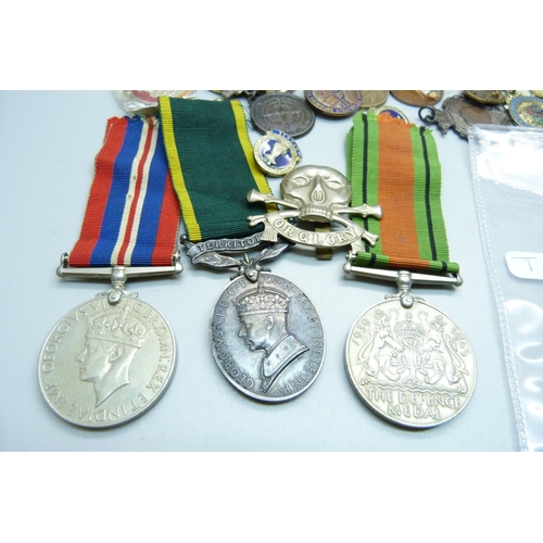 847 - A collection of medals including a Territorial medal, badges, etc.