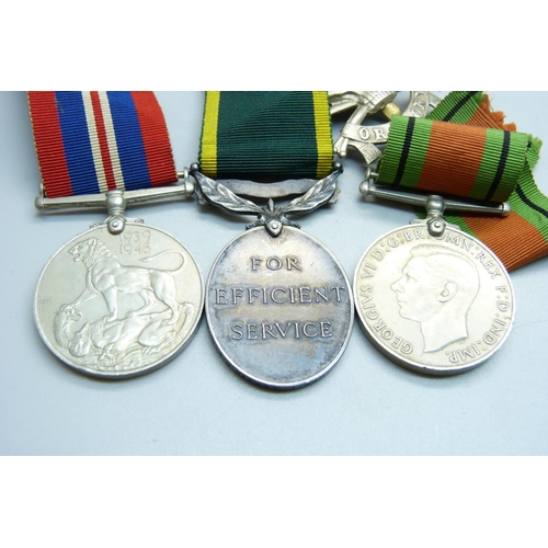 847 - A collection of medals including a Territorial medal, badges, etc.