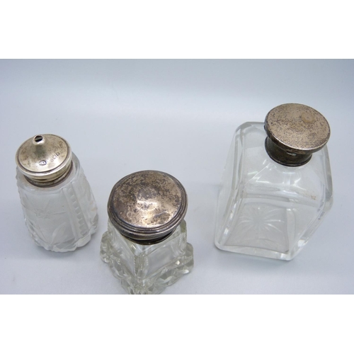 854 - A hallmarked silver topped salt pot and two silver topped scent bottles, (one is hallmarked, the oth... 