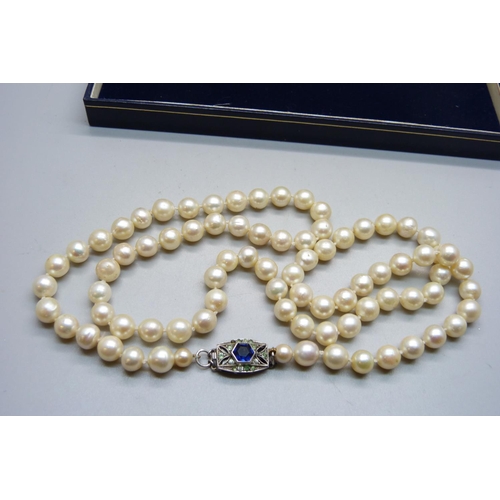 856 - A long string of large cultured pearls on a silver and paste clasp, approximately 82cm long, pearls ... 