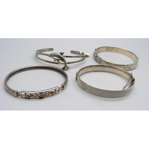 863 - Four silver bangles, 66g