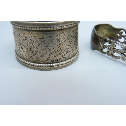 868 - A pair of pierced silver sugar bows, a silver napkin ring and a silver pencil holder, 58g