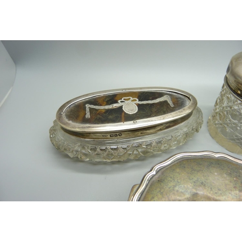 888 - A silver lidded pot, silver topped hair tidy, a silver and tortoiseshell topped box, a silver circul... 