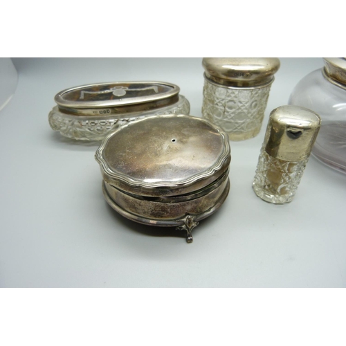 888 - A silver lidded pot, silver topped hair tidy, a silver and tortoiseshell topped box, a silver circul... 