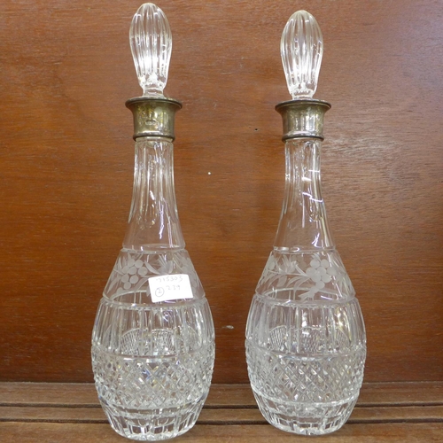 915A - A pair of silver rimmed crystal decanters