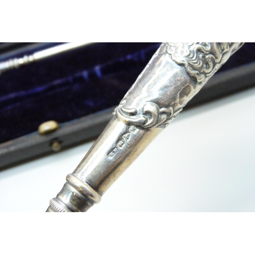 919 - A cased silver handled shoe horn and boot pull with Reynold's Angels decoration