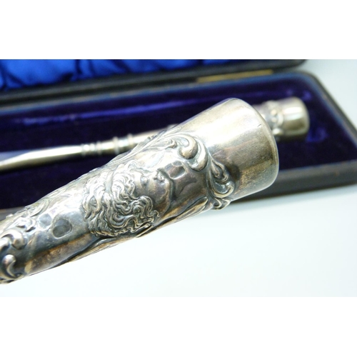 919 - A cased silver handled shoe horn and boot pull with Reynold's Angels decoration