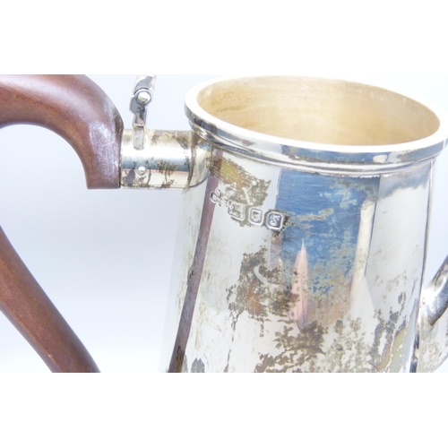 920 - A silver coffee pot with wooden handle, 742g