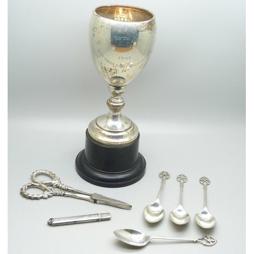 921 - A silver trophy, silver handled grape scissors, silver coffee spoons and a silver pencil holder