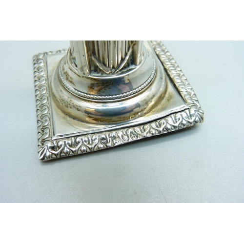 923 - A white metal Corinthian column candlestick, 11cm with stopper