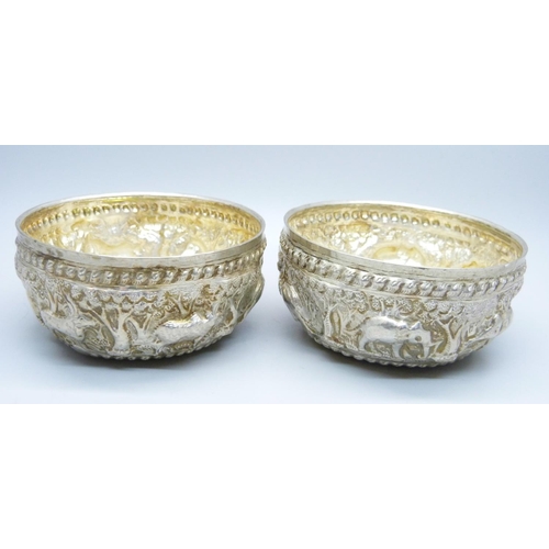 947 - A pair of African white metal embossed bowls, decorated with African wild animals, 144g