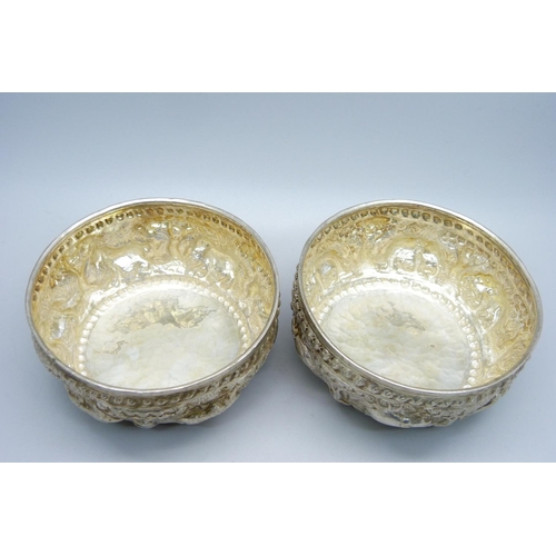 947 - A pair of African white metal embossed bowls, decorated with African wild animals, 144g