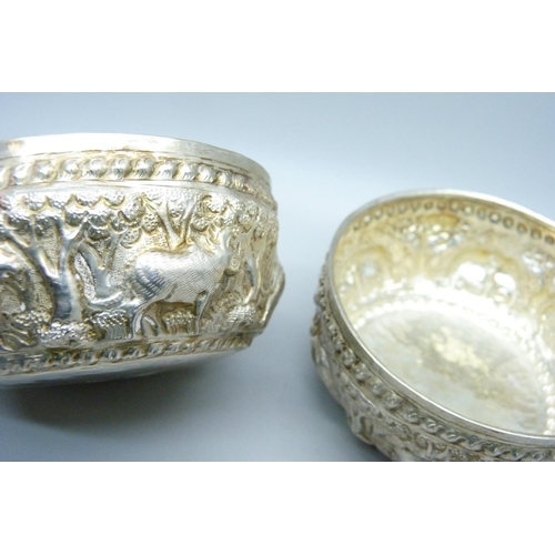 947 - A pair of African white metal embossed bowls, decorated with African wild animals, 144g