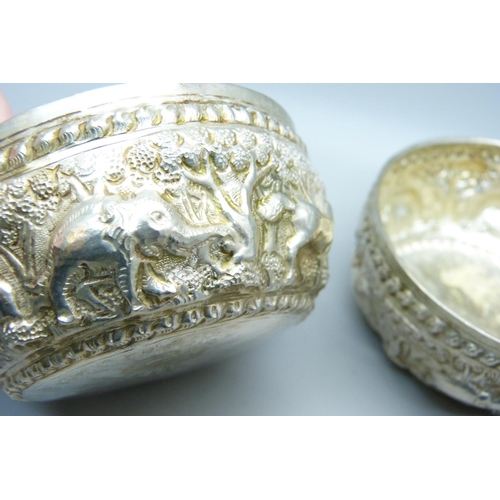 947 - A pair of African white metal embossed bowls, decorated with African wild animals, 144g