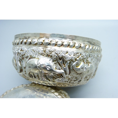 947 - A pair of African white metal embossed bowls, decorated with African wild animals, 144g