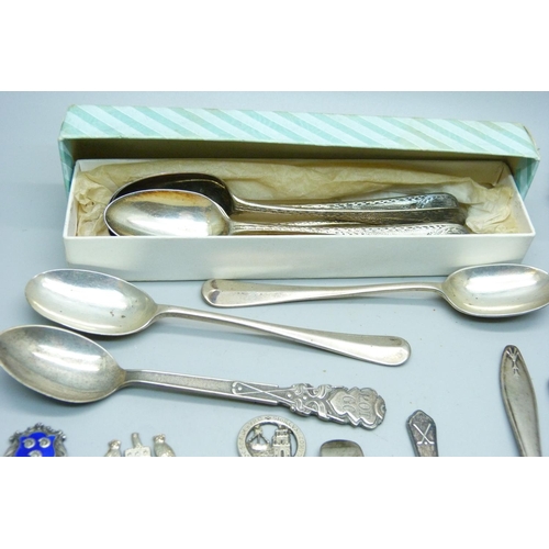 954 - Seven £1 banknotes, assorted silver teaspoons, coffee spoons and souvenir spoons, 275g