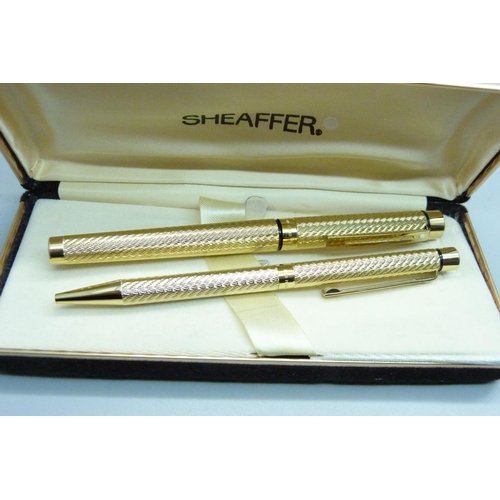 961 - A Sheaffer ink pen with 14k gold nib and ballpoint pen set, boxed and two Cross ballpoint pens, both... 