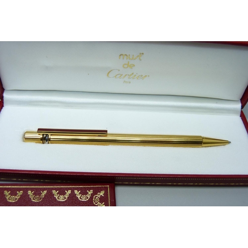 963 - A Must de Cartier rolled gold ballpoint pen, boxed