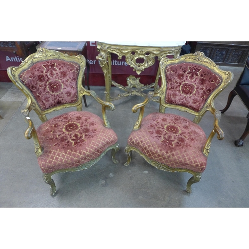 14 - A pair of French Louis XIV style carved giltwood and fabric upholstered fauteuil chairs