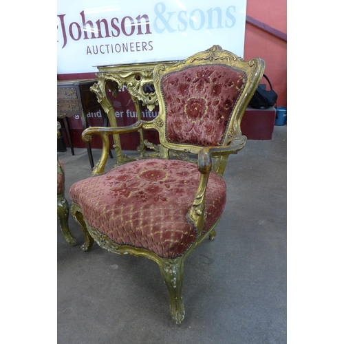 14 - A pair of French Louis XIV style carved giltwood and fabric upholstered fauteuil chairs