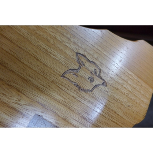 165 - An elm coffee table with, carved fox motif