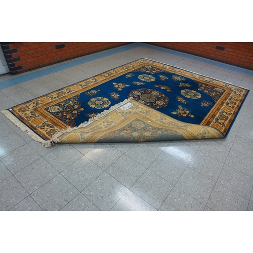 207 - A Belgian blue ground rug, 345 x 252cms