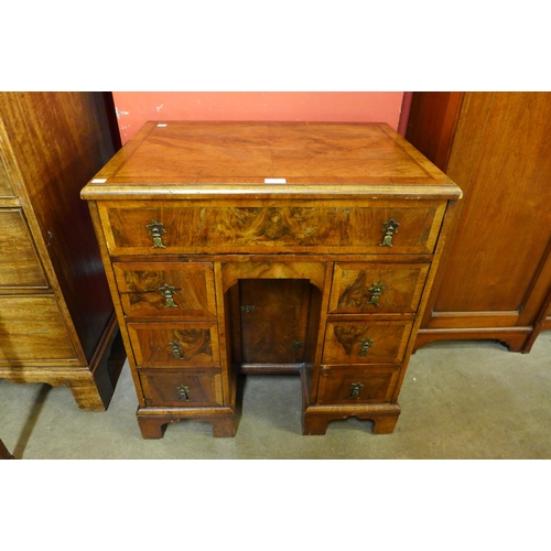 21 - A George I style figured walnut kneehole desk