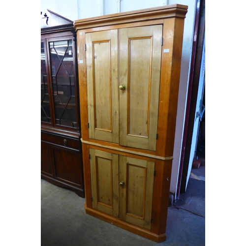 222 - A George III style pine freestanding corner cupboard