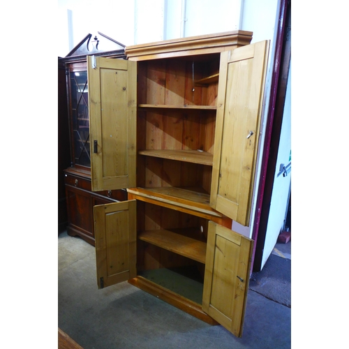 222 - A George III style pine freestanding corner cupboard