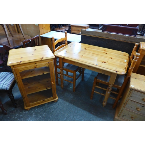 235 - A pine kitchen table, two chairs and a cabinet