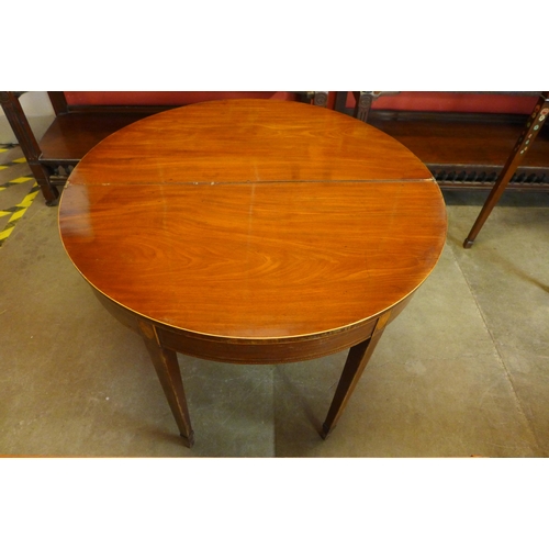 25 - A George III inlaid mahogany demi-lune fold over tea table