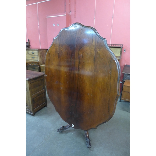 28 - An early Victorian rosewood serpentine tilt-top centre table