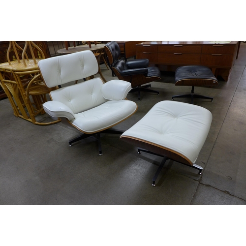 33 - A Ray & Charles Eames style simulated rosewood and white leather revolving lounge chair and ottoman