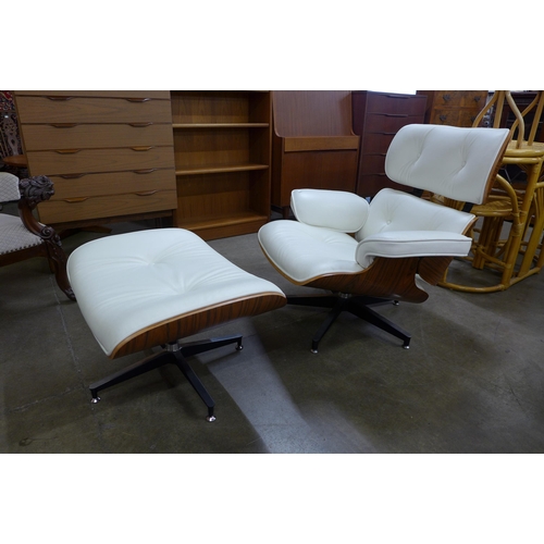 33 - A Ray & Charles Eames style simulated rosewood and white leather revolving lounge chair and ottoman