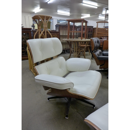 33 - A Ray & Charles Eames style simulated rosewood and white leather revolving lounge chair and ottoman